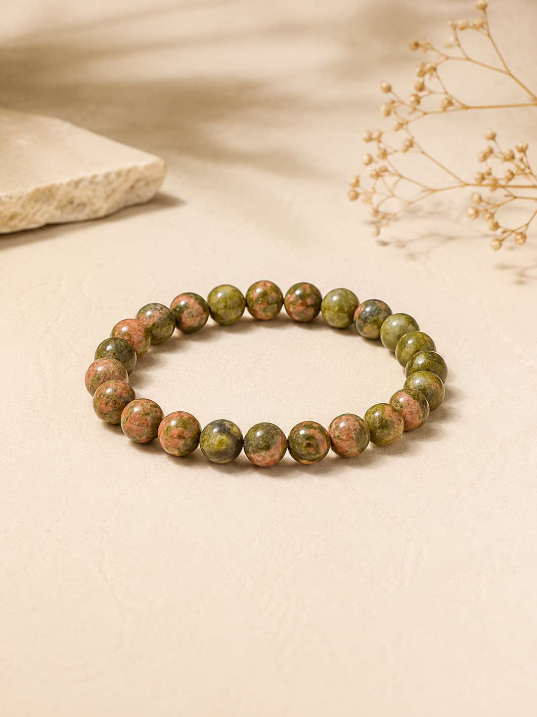 Unakite bracelet on a warm neutral surface